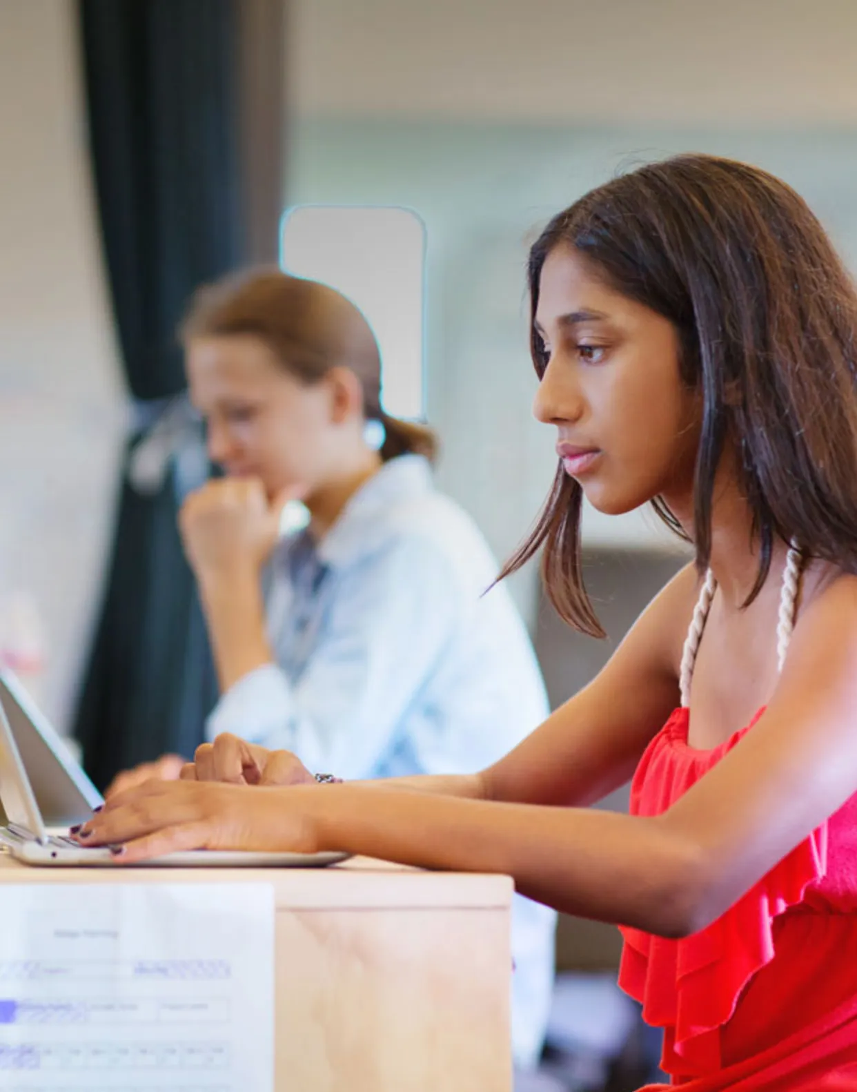 High school students working on laptops